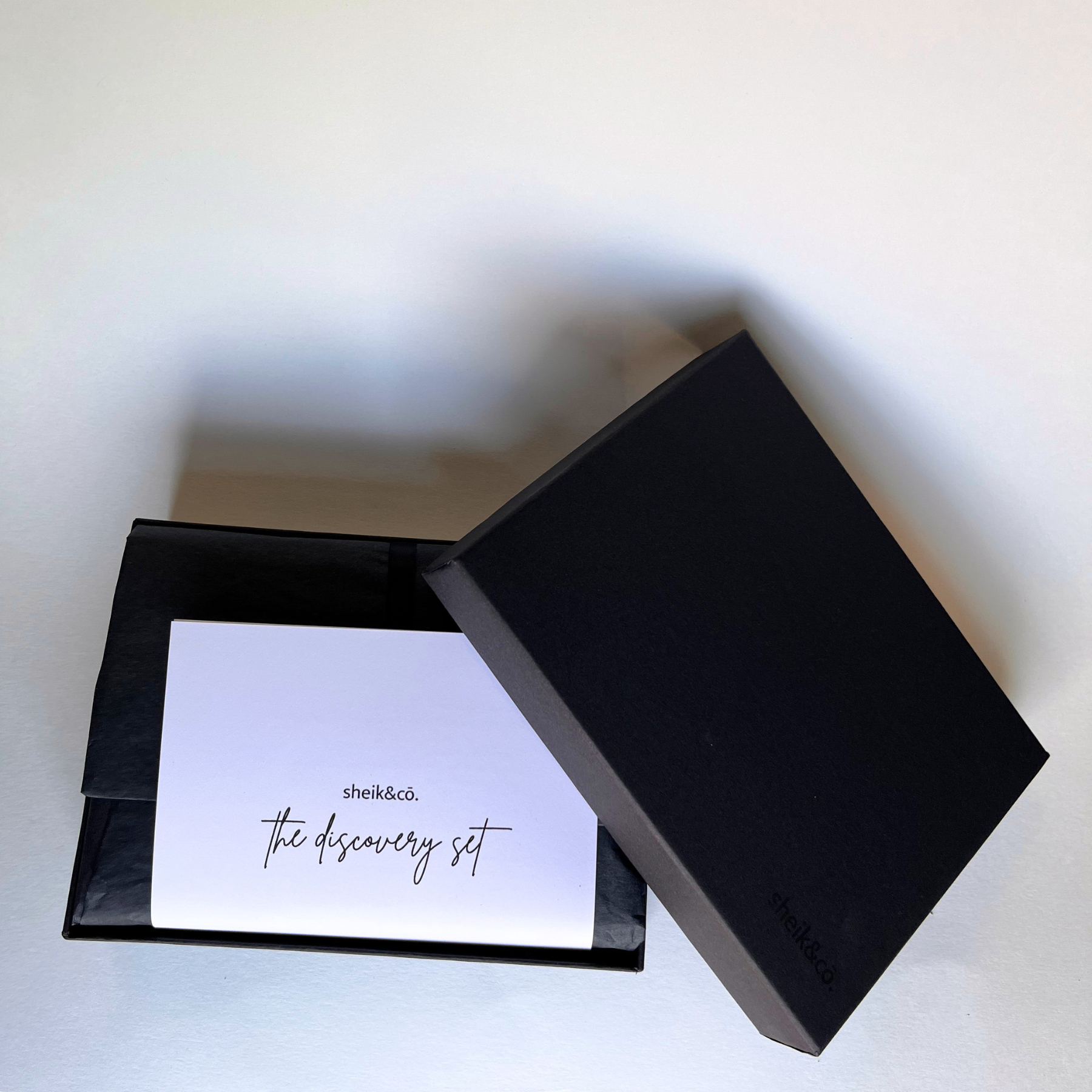 The Discovery Set of candles in Black gift box with a card inside on a white background